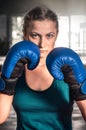ÃÂ¡lose up view of girl in boxing gloves training at gym. Young woman boxing in the gym